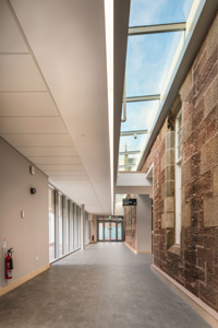 Corridor featuring Thermatex with skylights